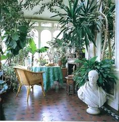 a room filled with lots of plants next to a window