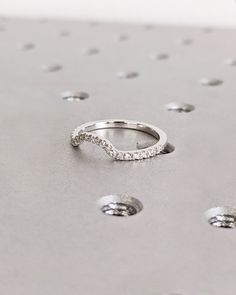 a diamond ring sitting on top of a metal surface