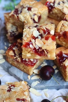 several pieces of cake with cherries and almonds