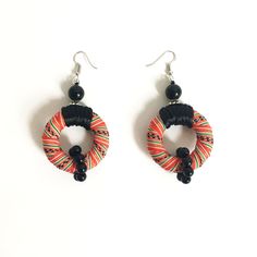 two pairs of earrings with black beads and red, green, yellow and orange colors