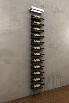 a wine rack with several bottles of wine on it in front of a concrete wall