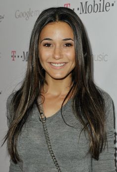 a woman with long hair smiling at the camera