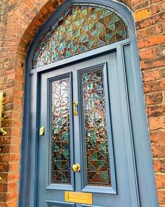 a blue front door with stained glass windows