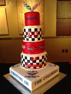 a three tiered cake is decorated with red and white checkered designs on top