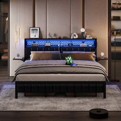 a bedroom with a large bed and blue lights on the headboard in front of it