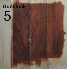 some brown paint is on the side of a wooden wall with words gunstock 5