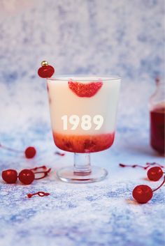 an old fashioned cocktail is garnished with cherries