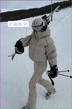 a person on skis holding up a sign with the word jacke in it