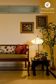 a living room with two couches and a lamp on the table next to it