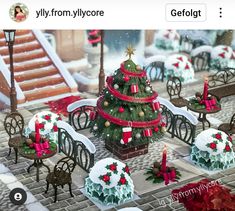 a christmas tree surrounded by small tables and chairs with decorations on them in the snow