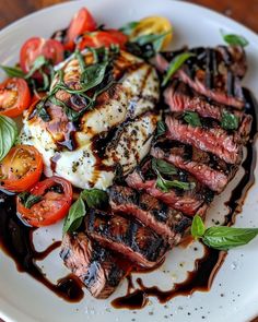 grilled steak with tomatoes, mozzarella and spinach on a white plate