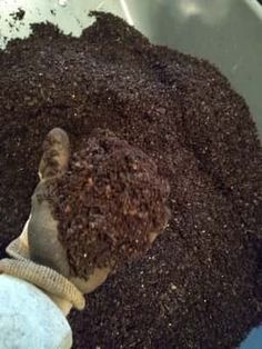 a pile of dirt sitting on top of a metal bucket