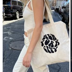 Ivory Cream White Tote Bag With The New York City Graphic Printed In Faded Black On The Front. All Accessories Are Final Sale. Fabrics: 100% Cotton Measurement: 15" (38 Cm) Length, 15" (38 Cm) Height, 28" (71 Cm) Full Bag Length Made In: China Bnwt Neutral Tote Bag For Day Out, Everyday Beige Canvas Bag With Dust Bag, Trendy Neutral Bags For Day Out, Trendy Neutral Bag For Day Out, New York City Graphic, Cheetah Bag, City Tote Bag, Baby Tote Bag, City Graphic