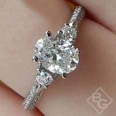 a close up view of a diamond ring on someone's finger