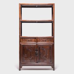 an old wooden shelf with two doors and drawers