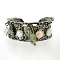 Introducing a unique silver cuff bracelet from Porans collection. This stunning piece features a silver coin, Aventurine bead, and 5 freshwater pearls that dangle elegantly. With its flexible design, it can comfortably fit any wrist. DIMENSIONS - Max Width: 26 mm / 1.04 inches Please contact me with any questions. Visit our silver watches shop: http://www.etsy.com/shop/PoransWatches More of our jewelry: http://www.etsy.com/shop/Porans Follow us: Pinterest - https://www.pinterest.com/porans0483/ Silver Fusion Cuff Bracelet With Oyster Design, Adjustable Silver Fusion Cuff Bracelet, Handcrafted Silver Bangle, Unique Nickel-free Bracelet For Anniversary, Unique Bangle With Lost Wax Casting, Silver Bohemian Hand-cast Bracelets, Bohemian Silver Hand-cast Bracelets, Bohemian Silver Hand Cast Bracelets, Silver Bracelet Jewelry In Wearable Art Style