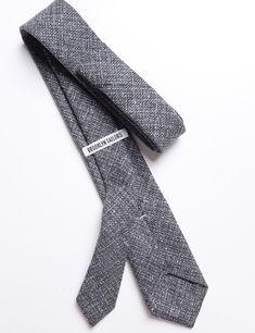 Our 'Standard Necktie' is made the right way - with a free-floating interlining and finished with a hand slip stitching and bar tack. The shape is slim, but not 'skinny'. They are also just a bit shorter than most ties, since we like them to hit just above the waistline, rather than below. DETAILS & CARE PATTERN & TEXTURE: This basketweave wool fabric has loads of texture. COLOR: "Ash" - Overall, a mid gray color. But, when you look closer, you'll notice a mix of lighter grays and very dark gray Fitted Spring Office Tie, Modern Fitted Ties For Formal Occasions, Spring Black Tie Event Ties, Wool Business Suit And Tie Accessories, Fitted Standard Tie For Black Tie Events, Wool Suit And Tie Accessories For Business, Business Wool Suit And Tie Accessories, Fitted Tie For Black Tie Events, Modern Fitted Suit And Tie Accessories For Business