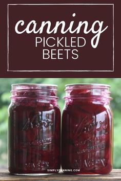 two jars filled with beets sitting on top of a wooden table