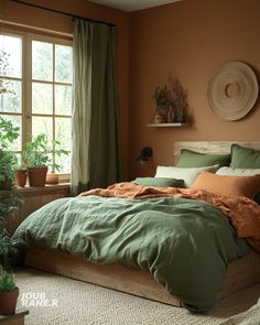 a bed with green sheets and pillows in a bedroom next to a window, potted plants