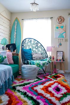 a bedroom with a colorful rug and surfboard on the wall