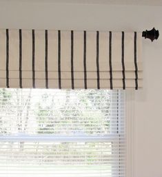 a window with black and white striped blinds