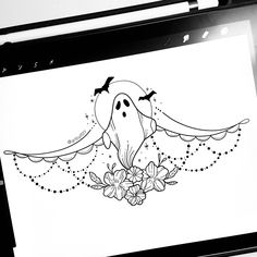 a computer screen with a drawing of a ghost on it's face and flowers in the foreground