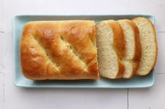 a loaf of bread cut in half on a blue plate