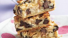 three bars stacked on top of each other with chocolate chips and nuts in the middle