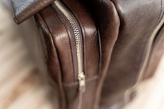 Fly in style next time you take a business trip or vacation with our limited edition brown Leather Flight Bag. This leather bag is finely handcrafted from the highest quality American Bison hides and 100% Made in USA. Any artisan that plays a part in handcrafting your flight bag adds their initials inside, making each flight bag unique. Each handmade vintage leather flight bag fits perfectly in an overhead compartment of an airplane so you can travel quick and easy with this carry on bag. Not on Brown Travel Backpack With Smooth Grain, Travel Backpack With Smooth Grain In Brown, Luxury Brown Leather Backpack For Everyday, Luxury Brown Rectangular Leather Backpack, Brown Smooth Grain Travel Backpack, Brown Rectangular Leather Backpack With Leather Handles, Brown Leather Backpack With Rectangular Shape, Brown Leather Backpack With Leather Handles, Luxury Brown Satchel Shaped As Backpack