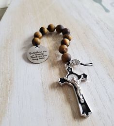 "Godfather rosary beads for any religious occasion   10mm smooth round matte tigers eye gemstone beads hand knotted using nylon thread.  High quality detailed crucifix with black enamel inlay.  Stainless steel charm with cross  cutout and laser engraved. \"Godfathers are a blessing, thank you for being mine\"" Spiritual Brown Rosary Bracelet For Gift, Adjustable Spiritual Rosary As Gift, Adjustable Brown Spiritual Rosary, Gift Rosary With 8mm Beads And Cross Shape, Gift Rosary Bracelet With 8mm Beads And Crucifix, Spiritual Crucifix Rosary As Gift, Gifts For Godfather, Godfather Proposal, Cross Cutout