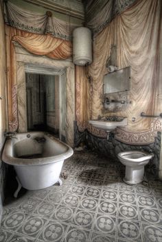 an old bathroom with a tub, toilet and sink