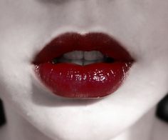 a woman with red lips and white makeup