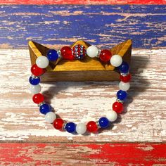 Your patriotism will be on full display with this stunning red, white and blue gemstone bracelet.  ◾ This bracelet is gender neutral, perfect for women and men to wear. 💎 One of the best benefits of the Jade gemstone is that it's a protective stone that promotes harmony. This is the perfect bracelet to wear on Labor Day, 4th of July, Memorial Day, Flag Day, Patriot Day, or any time you want to celebrate the USA! 📿 𝓑𝓻𝓪𝓬𝓮𝓵𝓮𝓽 𝓒𝓪𝓻𝓮 ◼️ Gently roll your bracelet on and off your wrist to Usa Bracelet, Military Bracelet, Patriotic Bracelet, Patriot Day, Blue Gemstone Bracelet, Engraved Cuff, Beaded Leather Bracelet, Awareness Bracelet, Jade Gemstone