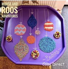 a purple tray with ornaments hanging from it's sides and text reading mouse and roos adventures