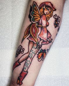 a woman's leg with a tattoo on it and an image of a fairy