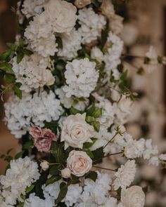 white and pink flowers are in a vase