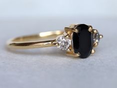 a close up of a black and white diamond ring