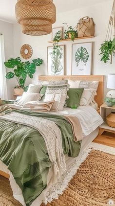 a bed with green sheets and pillows in a bedroom next to plants on the wall