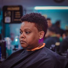 a woman getting her hair cut in a salon