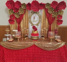 a red and gold table topped with a cake