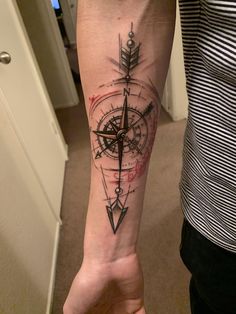 a person with a compass tattoo on their arm