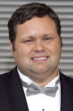 a man wearing a suit and bow tie