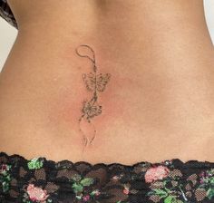 a woman's stomach with a tattoo on it