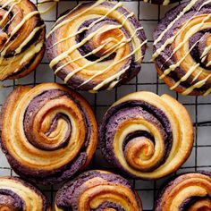 some very tasty looking pastries that are on a cooling rack with icing