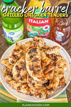 grilled chicken tenders on a white plate next to jars of barbecue sauce and seasoning