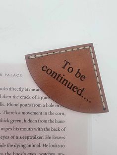 a leather bookmark with the words to be continued on it