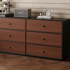 there is a dresser with many drawers and clocks on top of it in the room