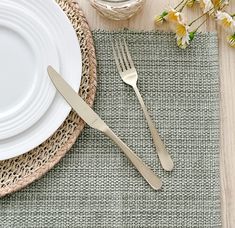 a place setting with silverware and flowers