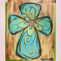 a painting of a blue cross with swirls on it's center and green border