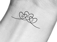 two hearts with the word love written on them are shown in black and white ink